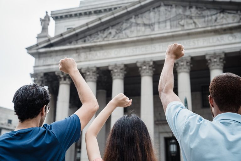 men and a woman protesting in front of the supreme court of the united states